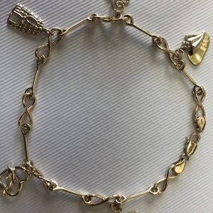 Solid 14 k gold and 10 k gold charms anklet.